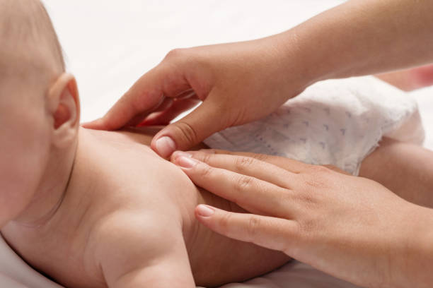 baby massage, close-up hands on baby back