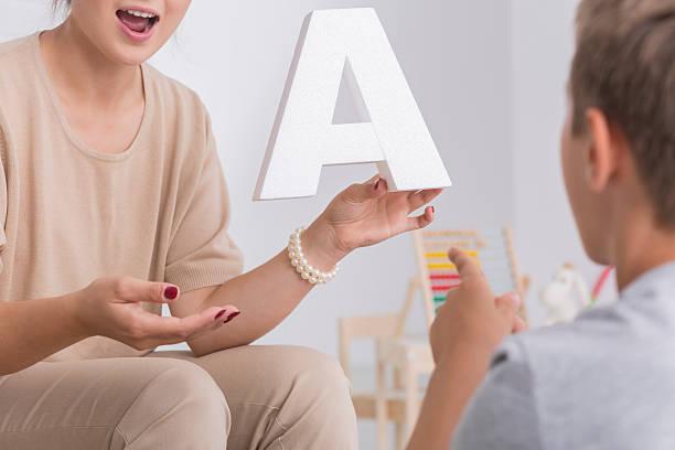 Shot of a little boy having a meeting with speech therapist
